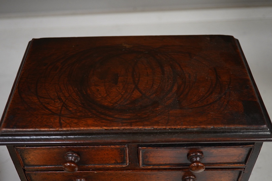 A 19th century miniature mahogany chest of five drawers, 28cm high. Condition - fair to good